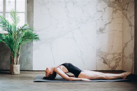 Woman Lying On Gray Yoga Mat · Free Stock Photo