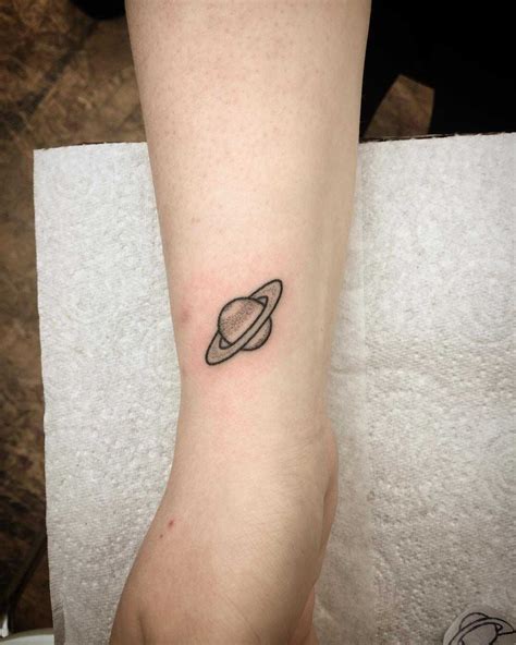 Little Saturn Tattoo By Kirk Budden Inked On The Right Wrist Saturn