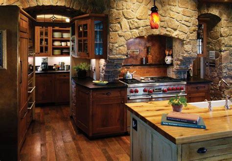 A Rustic Kitchen With Stone Walls And Wood Flooring An Island In The