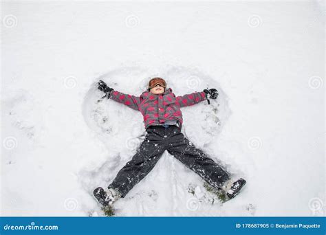 Boy Making A Snow Angel In The Snow Stock Image Image Of White