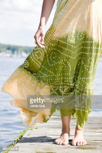 Wind Blowing Dress Of Woman Standing On Dock High Res Stock Photo