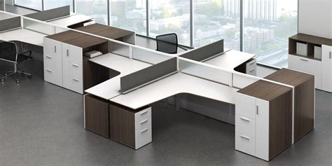 An Office Cubicle With Two Desks And One Chair