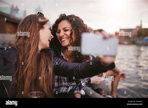 Cheerful Young Women Friends Taking Selfie By The Lake Best Friends Having Fun Together Stock