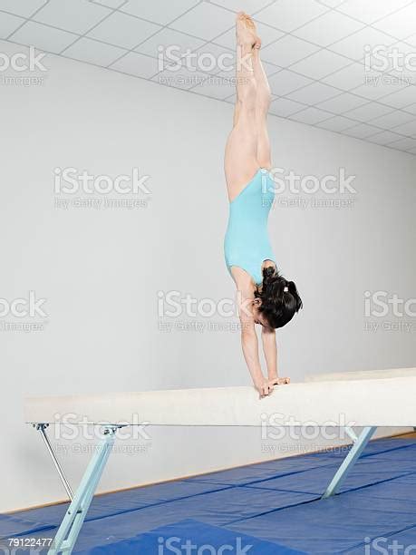Girl Doing Handstand On Balance Beam Stock Photo Download Image Now