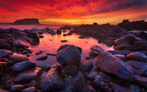 Sunrise In Minnamurra Australia Sea Coast With Rocks Ocean Sky With Red