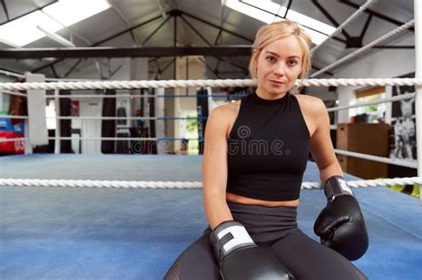 Portrait Of Female Boxer With Gum Shield In Gym Wearing Boxing Gloves