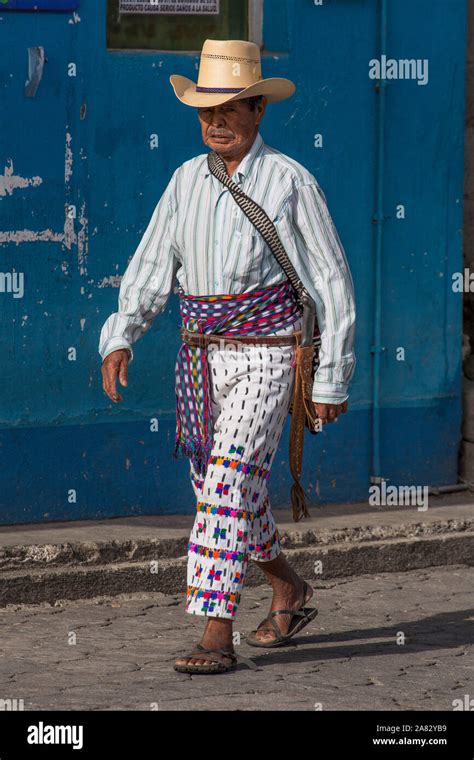 An Older Mayan Man Walking Along A Street In The Traditional Dress