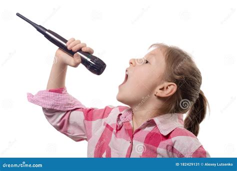 Little Cute Girl Singing Into A Microphone On A White Background Stock