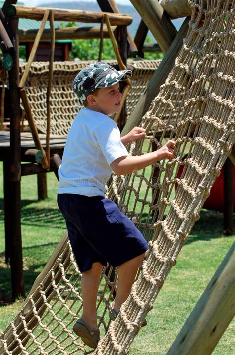 Boy Climbing A Rope Ladder In Playground Stock Image Image Of Funpark