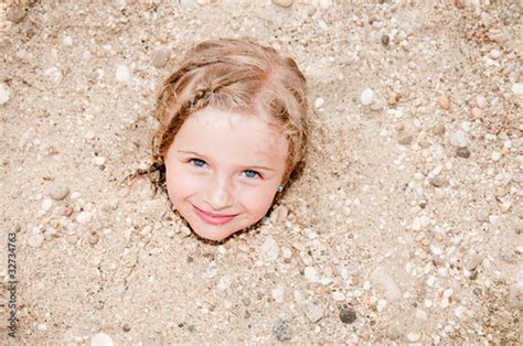 Little Girl Buried In The Sand Of The Beach Stock Photo Adobe Stock