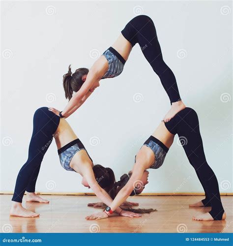Acro Yoga Three Sporty Girls Practice Yoga In Pair Partner Yoga