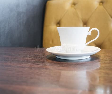 Coffee Cup On Table In Restaurant Cafe With Sofa Background Stock Image