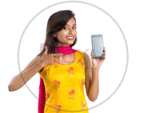 Image Of Beautiful Young Indian Girl Showing Mobile Screen With Smile