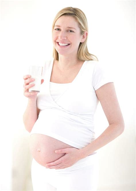 Pregnant Woman Drinking Milk Photograph By Ian Hooton Science Photo Library