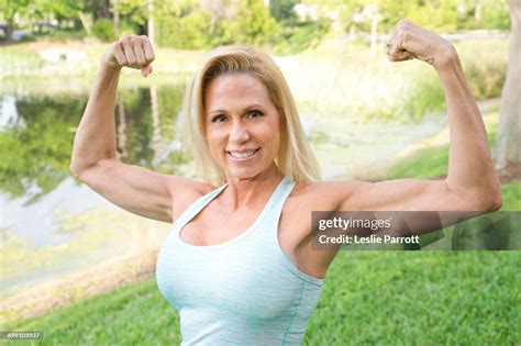 Woman Flexing Her Arm Muscles High Res Stock Photo Getty Images