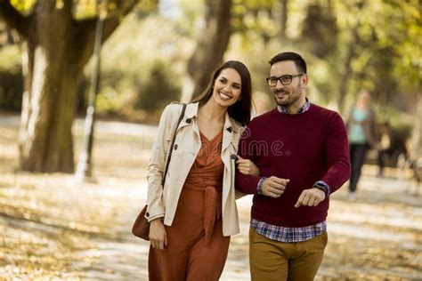 Loving Young Woman And Man Walking In Park Holding Hands Stock Image