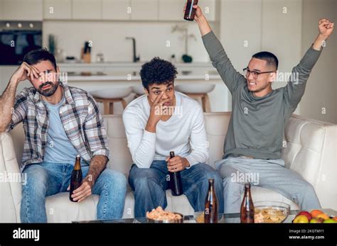 Pleased Guy Gloating Over His Upset Friends Stock Photo Alamy