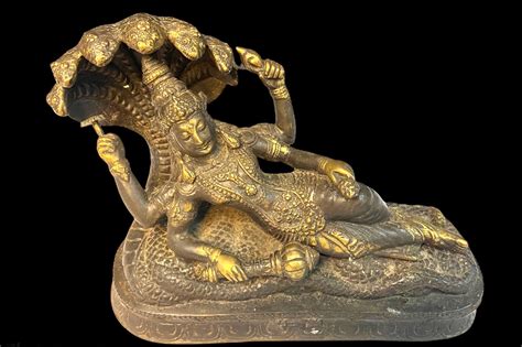 A Beautiful Sculpture Of Vishnu Shown Laying On The Coils Of The Cosmic Serpent Ananta Shesha
