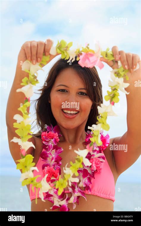 A Beautiful Young Hawaiian Girls Offers You An Orchid Flower Lei Stock