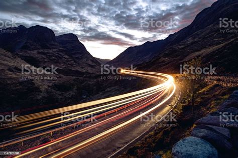 Light Trails In The Night On A Remote Road In Mountains Stock Photo