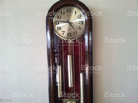 Grandfathers Time Big Floor Standing Antique Clock Along White Wall