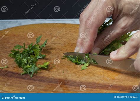 Men S Hands Cut Parsley With A Knife On A Cutting Board Stock Image