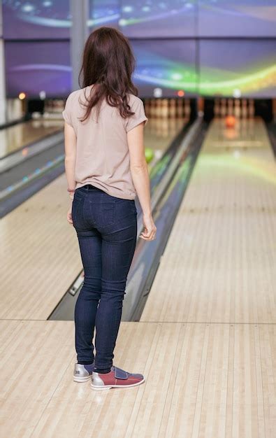 Premium Photo A Woman Throws A Ball Into A Bowling Alley Paths With