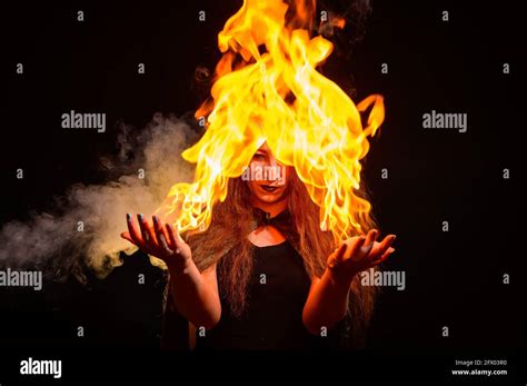 An Evil Red Haired Witch Holds Fire In Her Hands Stock Photo Alamy