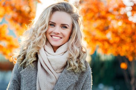 Beautiful Smiling Blond Woman With Curly Hair And Blue