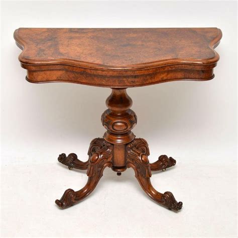 The structure is made of glossy tan lacquered wood with a felt top. Antique Victorian Burr Walnut Card Table For Sale at 1stdibs
