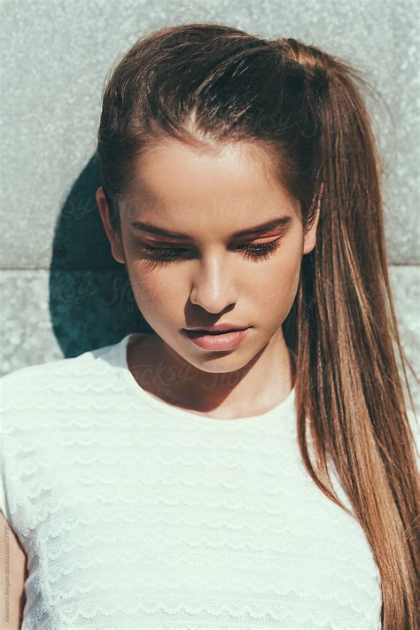 Sunlit Portrait Of A Young Woman Looking Down By Aleksandra Bergam