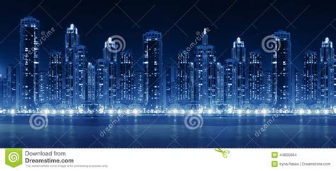 Modern City Skyline At Night With Illuminated Skyscrapers Stock Photo