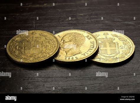 Italian 20 Lira Gold Coins On Rustic Wooden Background Stock Photo Alamy