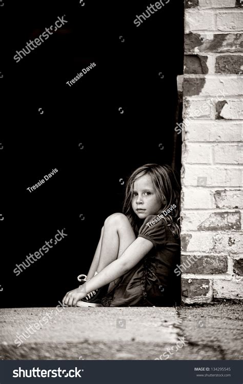 Sad Little Girl Sitting Alone On Stock Photo 134295545