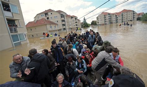 A Group Is Evacuated On An Amphibious Vehicle Over Flooded Streets In