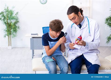 Young Male Doctor Examining Boy In The Clinic Stock Photo Image Of