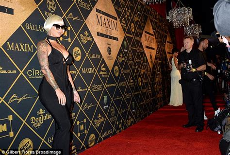 amber rose nearly bursts out of daringly low cut jumpsuit at maxim hot 100 party daily mail online