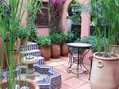 An Outdoor Patio With Potted Plants And Tables