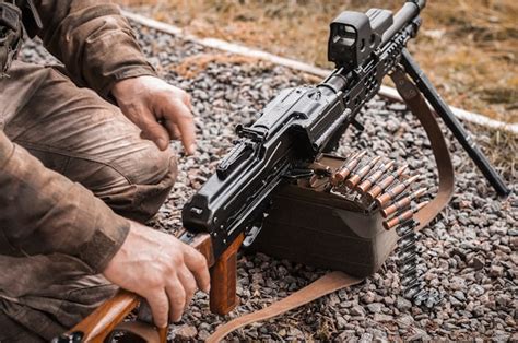 Premium Photo Image Of A Soldier Equipping A Heavy Machine Gun The