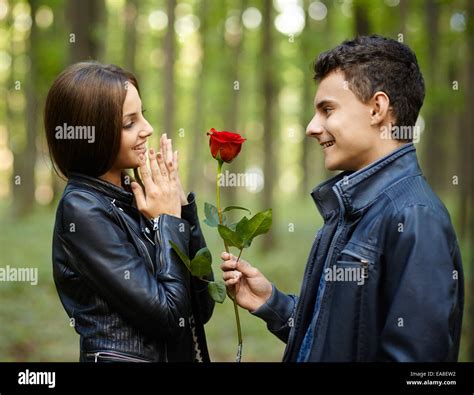 Teenage Romance A Boy Giving A Flower To His Girlfriend Outdoor In