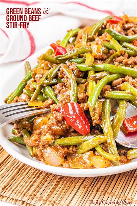 Green Beans And Ground Beef Stir Fry On A White Plate With A Fork In It