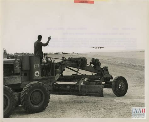 A Seabee In A Road Grader Waves As A Boeing B 29 Superfortress Prepares