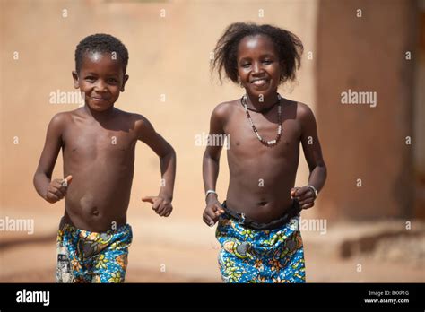 Two Fulani Children Run Towards The Camera In Djibo In Northern Burkina
