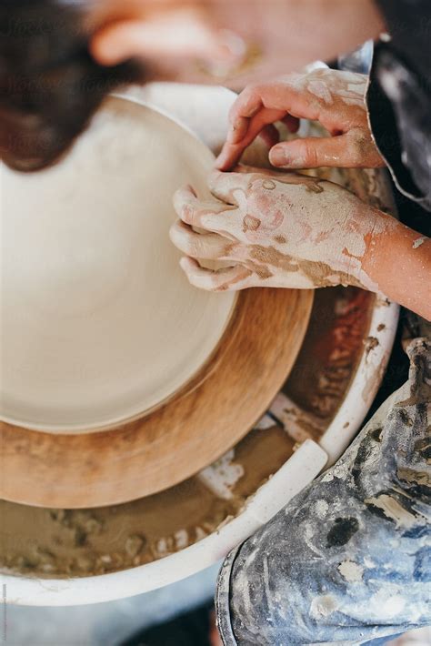 Woman Making A Ceramic Plate On A Turning Wheel By Stocksy Contributor Aila Images Stocksy