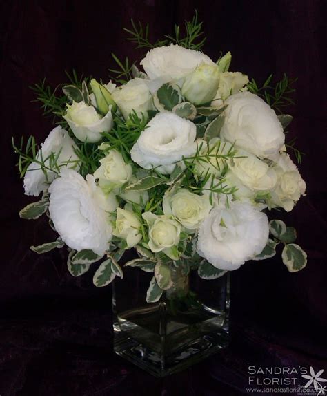 I thought a substantial floral arrangement in the center with a few photos placed around. 50th wedding anniversary floral arrangements | White Rose ...