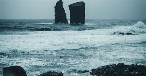 Black Rocks On Ocean · Free Stock Photo