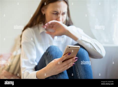 Crying Young Woman In Depression Looking At Phone Gets Bad News