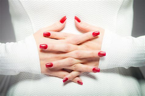 Two Interlaced Hands With Red Nails Stock Photo Download Image Now