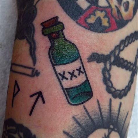 A Small Traditional Style Tattoo Of A Liquor Bottle Bottle Tattoo