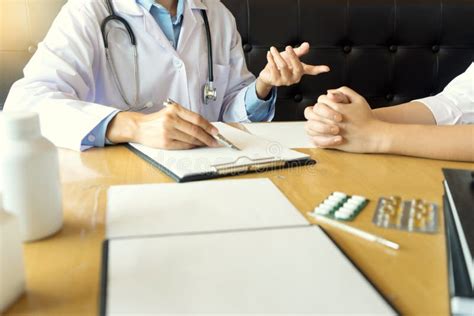 Doctor Explaining Patient Symptoms Or Asking A Question Stock Photo